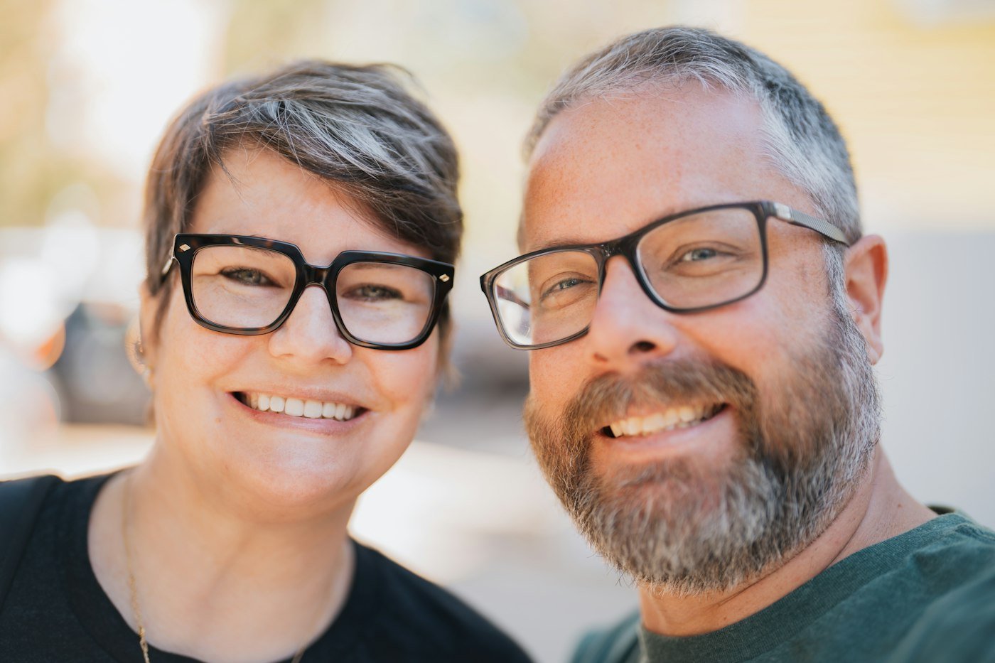 A smiling mid-life couple outdoors, relaxed and happy